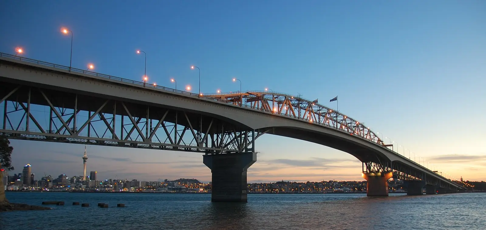 Auckland Harbour Bridge at sunset with the city beyond