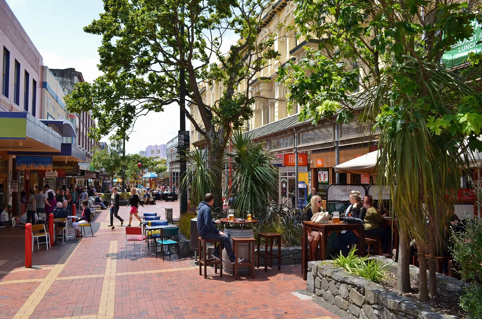 Outdoor cafe tables and pedestrians on Cuba Street in Wellington