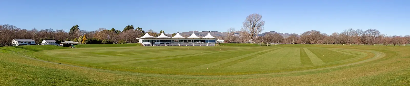 Hagley Oval pavilion and cricket ground in Christchurch with hills behind